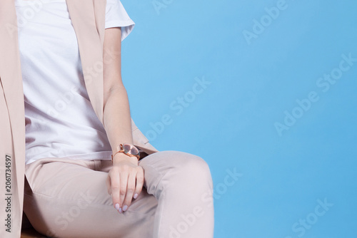 Cropped view of seated woman resting hand on lap studio