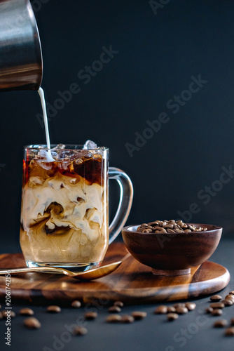 Canvas Print pouring creamer in coffee