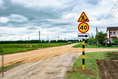 A road signs for construction work, warning about road repairs.