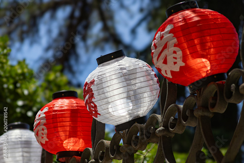 Japanese Red and White Paper Lanterns on Ornamental Iron Fence During Cultural Festival