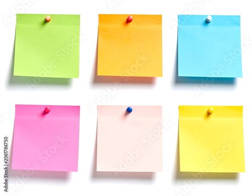 A set of six colorful sticky notes pinned on a white background