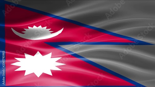 Nepalese national flag waving in wind with mountain landscape background and cloudy sky