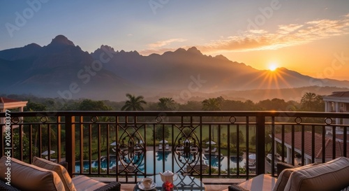 Scenic mountain sunset view from luxury hotel balcony.