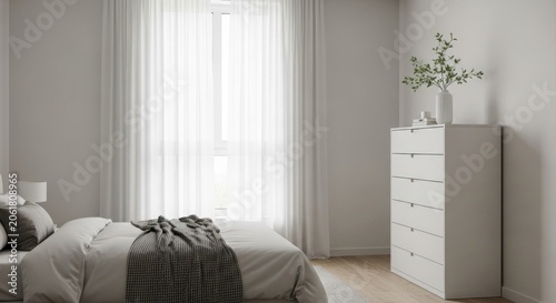 Simple white bedroom interior with dresser and sunlight.