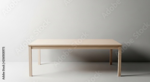 Simple wooden dining table against white wall.