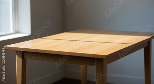 Simple wooden table in empty bright room near window