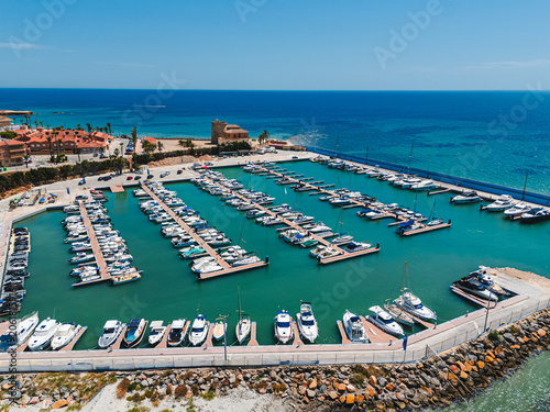Aerial view Torre de la Horadada marina filled with boats docked in the Mediterranean  Sea harbor. Costa Blanca, Alicante province, Spain