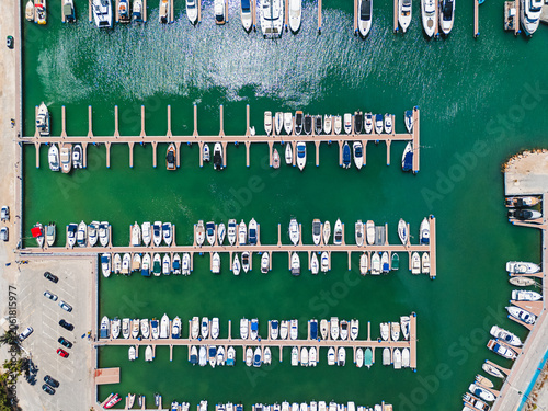Aerial view Torre de la Horadada marina filled with yachts docked in harbor. Maritime travel and coastal leisure concept for tourism and vacation. Costa Blanca, Alicante province, Spain