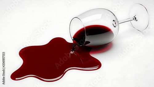 A spilled glass of red wine on a white surface creating a striking contrast.