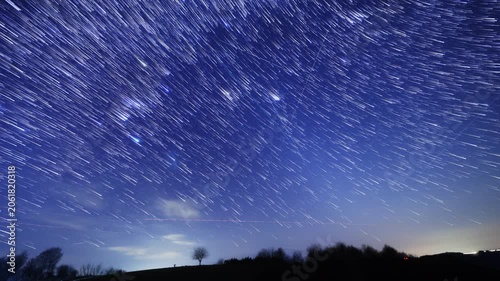 Orion constellation and Milky Way stars on a dark countryside skies. Time-lapse video.