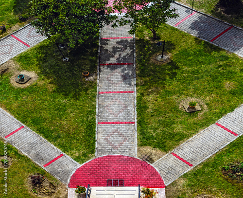 An example photo of garden pavements and trees with landscaping.