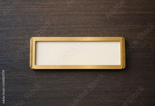Empty Gold Nameplate on Dark Textured Background Minimalist Flat Lay