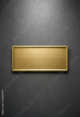 Minimalist Gold Nameplate on Dark Textured Background with Reflective Surface