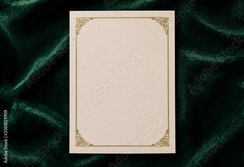 Blank ornate certificate frame on rich emerald green velvet background texture