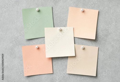 Five Pastel Sticky Notes Pinned on a Textured Gray Background, Flat Lay