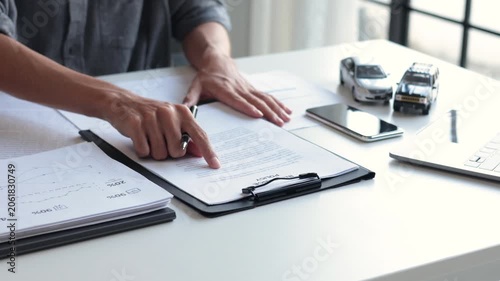 Businessman Reviewing and Signing Car Insurance Policy Contract, Auto Loan Agreement Contract in Office.