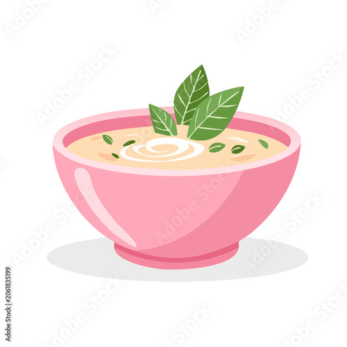 Pink bowl of creamy soup with green leaf garnish