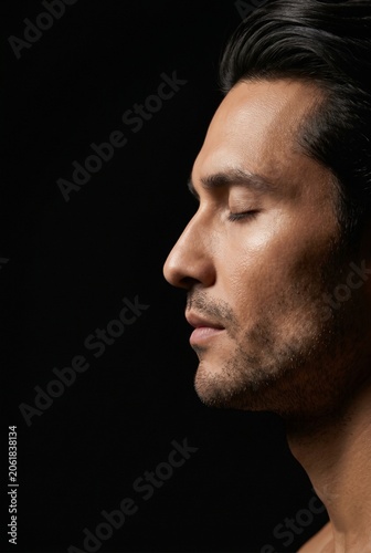 Side profile portrait of a man with closed eyes