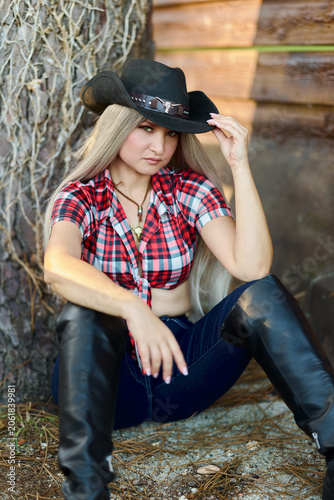 Outdoor portrait of woman wearing hat and plaid shirt