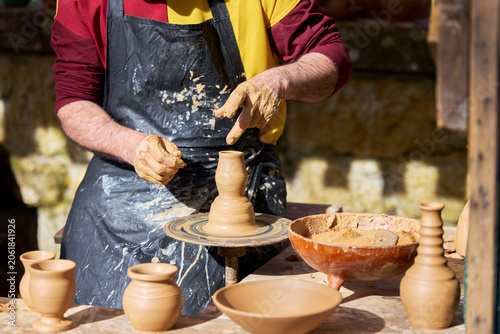 Hands Shaping Clay On Pottery Wheel