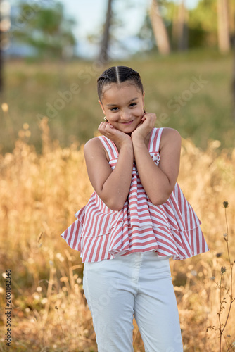Smiling Young Girl With Hands Near Face