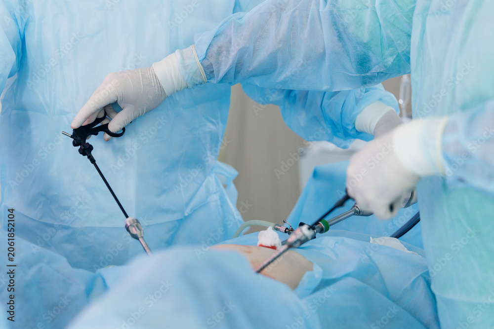 Naklejka premium Closeup Surgeons performing laparoscopic surgery in operating room