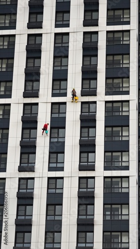industrial climbers on the wall of modern office building