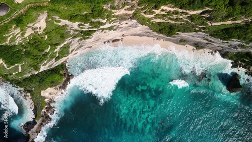 Rocky coastal headland with turquoise water aerial view Nusa Penida Bali drone