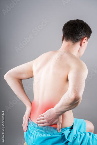 Back pain, kidney stones, inflammation and disease, man suffering from backache on grey background