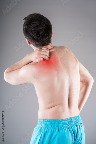 Man suffering from neck and shoulder pain. Massaging tense trapezius muscle. Office syndrome and backache medical concept