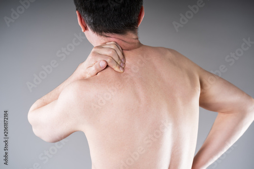Man suffering from neck and shoulder pain. Massaging tense trapezius muscle. Office syndrome and backache medical concept