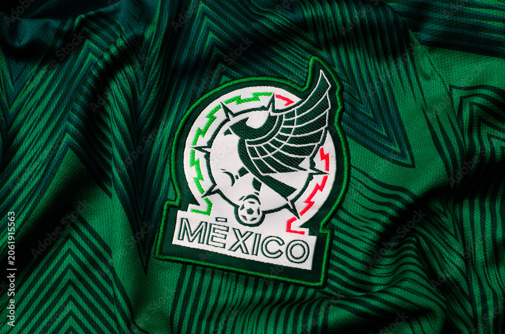 Naklejka premium Kyiv, Ukraine. June 16, 2026. Close-up of the Mexican national football team jersey featuring the official embroidered green and white crest.