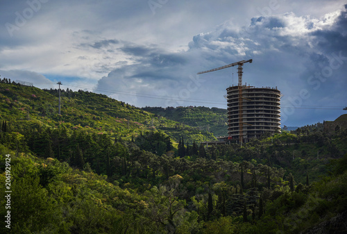Circular Tower Construction Site Surrounded by Forested Landscape