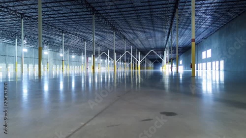 Large industrial facility with a long row of stell support colums, loading dock doors and polished concrete floor