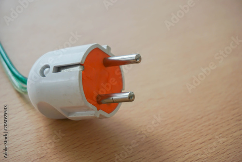 Quadro su tela A white European-style electrical plug with two round metal prongs is displayed
