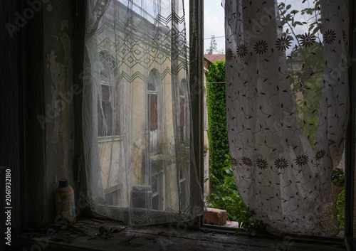 Abandoned Room Window with Lace Curtains and Overgrown Courtyard View