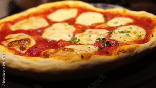 Putting fresh oregano on a pizza