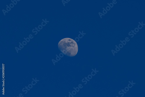 Fényképezés Waning gibbous moon visible in the bright blue sky during daytime
