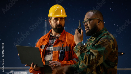 Εκτύπωση καμβά Military man on drilling rig speaks into walkie talkie, enforcing maritime blockade protocol with oil crisis and soldier with offshore platform