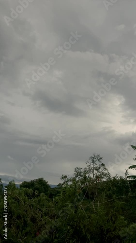 Gathering of stormy clouds over the farms and forest
