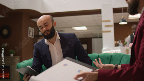 Vászonkép During global business gathering, managerial director proposes revolutionary input, with businessmen dressed properly acting with commitment, reviewing data on papers at hotel reception