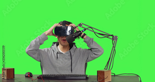 Quadro su tela POV of broadcaster using virtual reality eyewear to stream live action gaming while sitting at workstation playing web sports