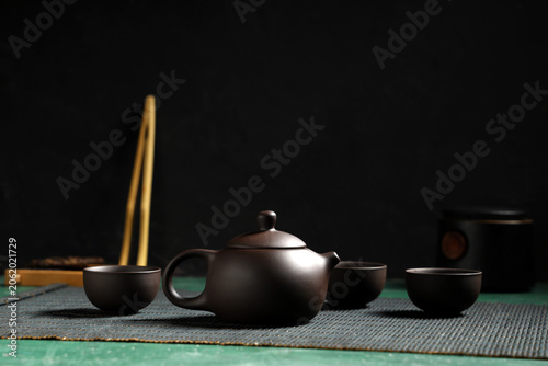 Teapot with cups of tea on ...
