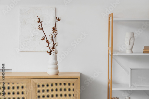 Vase with cotton flowers on...