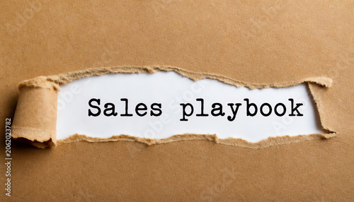 Sales playbook text on torn paper on the white background