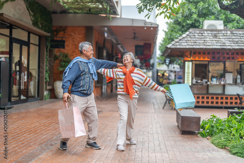 Fotografía Happy senior asian couple walking and laughing together outdoors, elderly husban