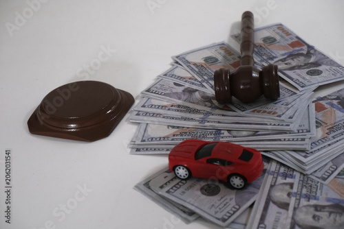Obraz na płótnie Court gavels, miniature cars, and dollar bills