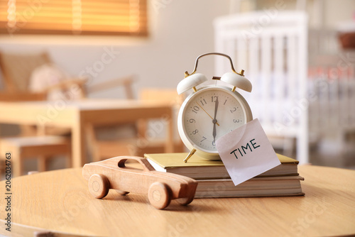 Alarm clock, books, toy and...