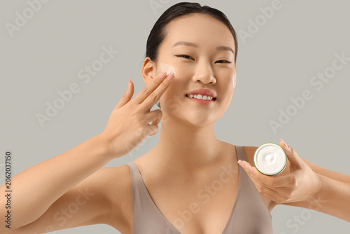 Young Asian woman applying ...