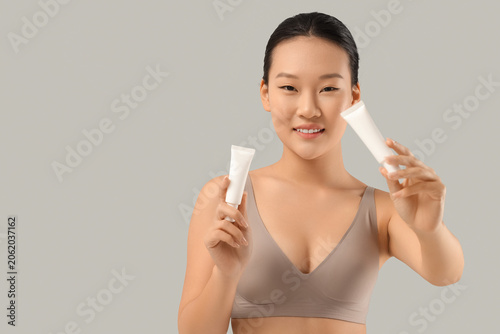 Young Asian woman in bra wi...